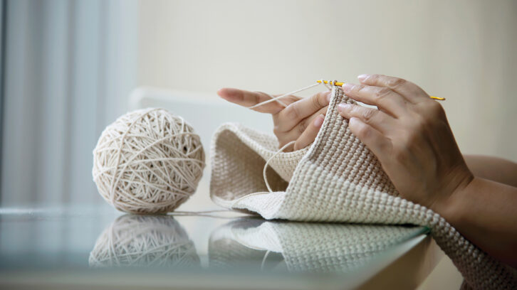 Woman's hands doing home knitting work