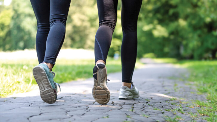 Female running feet in sport shoes