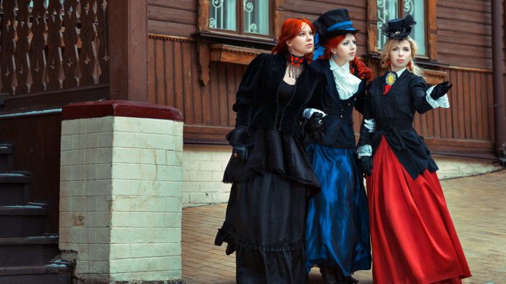 Three women dressed in Victorian-style costumes