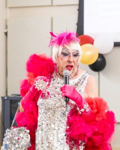 Miss Dewitt talking into a microphone