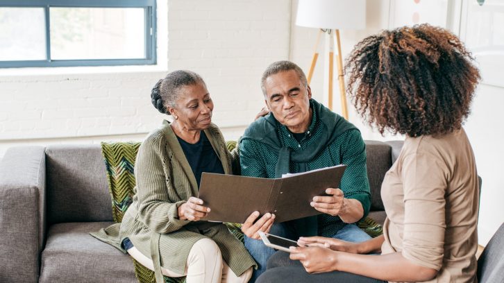 Couple speaking with caregiver